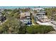 Aerial view of the home, highlighting the pool deck, outdoor living spaces and tropical landscaping at 140 N Casey Key Rd, Osprey, FL 34229