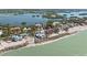 Beautiful aerial view of waterfront homes on a sandy beach with stunning water views at 140 N Casey Key Rd, Osprey, FL 34229