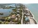 Coastal property with ocean views and access to the bay, nestled amidst lush greenery, creating a serene beachside retreat at 140 N Casey Key Rd, Osprey, FL 34229