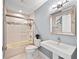 This bathroom features a tiled shower and a modern sink and mirror at 140 N Casey Key Rd, Osprey, FL 34229