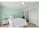 Inviting bedroom with soft aqua walls, a ceiling fan, and a closet with sliding doors at 140 N Casey Key Rd, Osprey, FL 34229