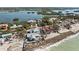 Waterfront homes boast beach access and bay views, surrounded by lush greenery in a serene coastal setting at 140 N Casey Key Rd, Osprey, FL 34229