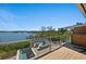 Deck showcasing outdoor seating and lovely water views at 140 N Casey Key Rd, Osprey, FL 34229