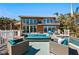 Exterior of home with pool, deck, patio furniture, and lush landscaping at 140 N Casey Key Rd, Osprey, FL 34229