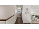 Second-floor hallway with decorative anchor, railing, and a view of the living room at 140 N Casey Key Rd, Osprey, FL 34229