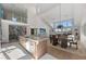 Open floor plan kitchen and living space with a large island and natural light at 140 N Casey Key Rd, Osprey, FL 34229