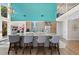 Stylish kitchen features a large island with barstool seating, modern appliances, and vibrant design at 140 N Casey Key Rd, Osprey, FL 34229