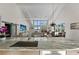 Open kitchen featuring a large island with sink and view into the living and dining areas at 140 N Casey Key Rd, Osprey, FL 34229