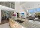 Contemporary open-plan kitchen showcasing a large island, sink, and seamless flow to the living area and staircase at 140 N Casey Key Rd, Osprey, FL 34229