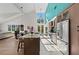 Modern kitchen and dining area with a large island, stainless steel appliances, and large windows at 140 N Casey Key Rd, Osprey, FL 34229