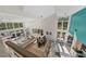 Bright, open-concept living room with high ceilings and plenty of natural light at 140 N Casey Key Rd, Osprey, FL 34229