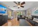 Well lit living room features wood floors, comfortable seating, and outdoor access at 140 N Casey Key Rd, Osprey, FL 34229