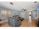 Open living room with wood floors, neutral walls, and comfortable gray sofa at 140 N Casey Key Rd, Osprey, FL 34229