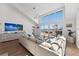 Bright living room with high ceilings, large windows, and a view of the water at 140 N Casey Key Rd, Osprey, FL 34229