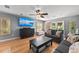 A large flatscreen TV is the focal point in this living room with hardwood floors at 140 N Casey Key Rd, Osprey, FL 34229