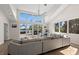 Spacious living room with large windows and a view of the water and outdoor deck at 140 N Casey Key Rd, Osprey, FL 34229