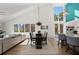 Open living space featuring dining room and living room with large windows and natural light at 140 N Casey Key Rd, Osprey, FL 34229