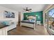 Well-lit main bedroom with a sliding glass door to the balcony and ensuite bathroom at 140 N Casey Key Rd, Osprey, FL 34229