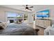 Cozy main bedroom with a waterfront view, balcony access, and a flatscreen television at 140 N Casey Key Rd, Osprey, FL 34229