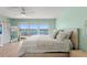 Serene main bedroom with water views, a white ceiling fan, and a cozy white bed at 140 N Casey Key Rd, Osprey, FL 34229