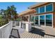 Outdoor kitchen area on a spacious deck, perfect for entertaining with water views at 140 N Casey Key Rd, Osprey, FL 34229
