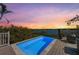 Stunning waterfront view from a deck featuring a refreshing, tiled plunge pool, and comfortable outdoor seating at 140 N Casey Key Rd, Osprey, FL 34229