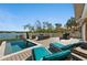 Lounge by the pool on the deck with outdoor kitchen and waterfront view at 140 N Casey Key Rd, Osprey, FL 34229