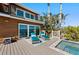 Deck with seating, lounge chairs, and pool with view of the waterway at 140 N Casey Key Rd, Osprey, FL 34229