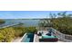 Outdoor pool and deck overlooking tranquil water views with outdoor seating at 140 N Casey Key Rd, Osprey, FL 34229
