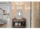 Nicely decorated powder room with a view of the living room through the door at 140 N Casey Key Rd, Osprey, FL 34229