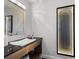 Contemporary powder room with stylish vanity, vessel sink, and modern lighting at 140 N Casey Key Rd, Osprey, FL 34229