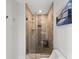 Luxurious walk-in shower with sleek glass doors and modern fixtures at 140 N Casey Key Rd, Osprey, FL 34229