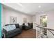 Comfortable sitting area with hardwood floors, large windows with a water view, and two plush grey chairs at 140 N Casey Key Rd, Osprey, FL 34229