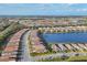 Aerial view of community showcasing various homes and lake at 14608 Derna Ter, Bradenton, FL 34211