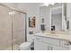 Modern bathroom with a walk-in shower and white cabinets at 14608 Derna Ter, Bradenton, FL 34211