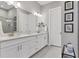 Double vanity bathroom with white cabinets and quartz countertops at 14608 Derna Ter, Bradenton, FL 34211