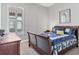 Charming bedroom with wooden sleigh bed and window shutters at 14608 Derna Ter, Bradenton, FL 34211