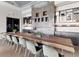 Long communal table and modern fireplace in the dining area at 14608 Derna Ter, Bradenton, FL 34211