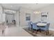 Formal dining room with round table and six blue chairs at 14608 Derna Ter, Bradenton, FL 34211