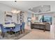 Dining area with round table, blue chairs, and gallery wall at 14608 Derna Ter, Bradenton, FL 34211