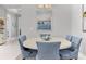 Bright dining room with a large round table and blue chairs at 14608 Derna Ter, Bradenton, FL 34211