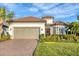 One-story home with tile roof, two-car garage, and landscaped front yard at 14608 Derna Ter, Bradenton, FL 34211