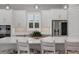 Modern kitchen with white cabinets, stainless steel appliances, and a large island at 14608 Derna Ter, Bradenton, FL 34211