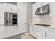 Modern kitchen with white cabinets, stainless steel appliances, and gas cooktop at 14608 Derna Ter, Bradenton, FL 34211