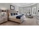 Spacious main bedroom with tufted headboard and sitting area at 14608 Derna Ter, Bradenton, FL 34211