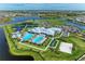 Amazing aerial view shows various community features including tennis courts, a pool, and clubhouse in a scenic setting at 15917 Clear Skies Pl, Lakewood Ranch, FL 34211