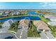 Aerial view of a single-story home showcasing the tile roof and the community lake at 15917 Clear Skies Pl, Lakewood Ranch, FL 34211