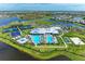 Beautiful aerial view of the Primary-planned community, showcasing tennis courts, pools, clubhouse, and bocce ball court at 15917 Clear Skies Pl, Lakewood Ranch, FL 34211