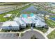Aerial view of the neighborhood clubhouse featuring pool, playground, sports courts, and ample parking at 15917 Clear Skies Pl, Lakewood Ranch, FL 34211