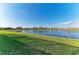 Expansive backyard featuring lush green grass and a tranquil lake at 15917 Clear Skies Pl, Lakewood Ranch, FL 34211